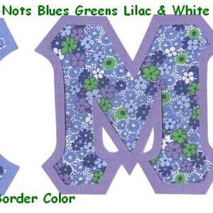 May include: Two fabric letters, X and M, with a forget-me-not floral pattern in shades of blue, green, and white. The letters have a solid blue border. #479 Packed Forget-Me-Nots Blues Greens Lilac & White UPick Border Color