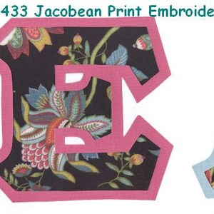 May include: Two large fabric letters, "E" and "A", with a black background and a floral pattern. The "E" has a pink outline and the "A" has a light blue outline.