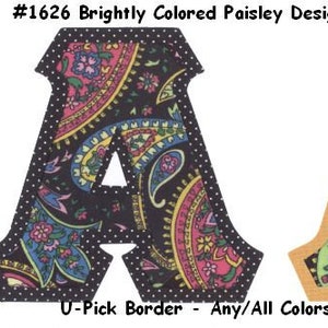 May include: Two decorative letter "A" designs. One has a black background with a white polka dot border and the other has a tan border. Both feature brightly colored paisley patterns in pink, yellow, blue, and green. The text "#1626 Brightly Colored Paisley Designs on Black" is at the top.