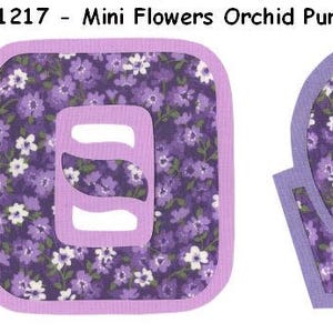 May include: Two purple and white fabric shapes with a floral pattern. The first shape is a square with a smaller square cut out in the center. The second shape is a horseshoe shape.