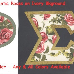 May include: Two fabric letters, "P" and "E", with a floral pattern of red roses on a white background. The letters are outlined in green and gold, respectively. The text "#960 Romantic Roses on Ivory Background" and "UPick Border - Any & All Colors Available" are also visible.