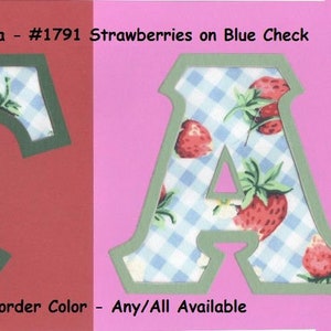 May include: The image shows the letters "T" and "A" with a strawberry and blue gingham pattern. The letters are outlined in green and set against red and pink backgrounds. Text at the top reads "Alpha To Omega - #1791 Strawberries on Blue Check."