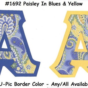 May include: Two letter A's cut out of fabric with a paisley pattern in shades of blue and yellow. The letter on the left has a blue border and the letter on the right has a yellow border. The text #1692 Paisley In Blues & Yellow is at the top of the image. The text U-Pic Border Color - Any/All Available is at the bottom of the image.