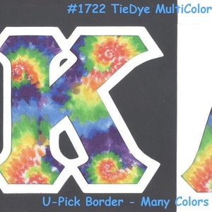 May include: Two large letters, "K" and "A", are cut out of tie-dye fabric with a white border. The fabric has a rainbow swirl pattern. The letters are on a black and white background. #1722 TieDye MultiColors U-Pick Border - Many Colors Available