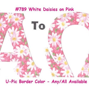 May include: Two fabric letters, A and O, in a pink and white daisy print. The letters are cut out and have a white background. The text "#789 White Daisies on Pink" and "To" are above the letters. The text "U-Pic Border Color - Any/All Available" is below the letters.