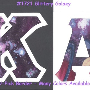 May include: Two fabric letters, K and A, with a galaxy print. The letters have a white outline and are on a black and white background. The text "#1721 Glittery Galaxy" is at the top of the image. The text "U-Pick Border - Many Colors Available" is at the bottom of the image.