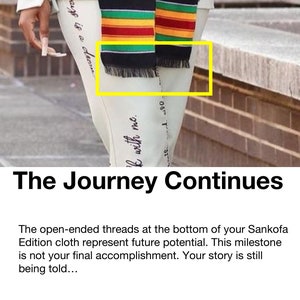 May include: A close-up of a Sankofa Edition cloth with black fringe. The cloth features stripes of red, yellow, and green. The text "The Journey Continues" is at the bottom of the image.