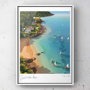 May include: A framed print of a coastal scene featuring a sandy beach, turquoise water, and sailboats. Lush green trees and white buildings line the shore. The print is signed and includes the word "Salcombe" in script.