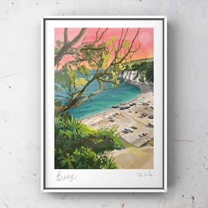 May include: Framed art print of a coastal landscape, showing a beach, boats, and cliffs. The artwork uses a vibrant colour palette with a pink and orange sky, turquoise water, and green foliage. The word "Beer" is written in cursive at the bottom.