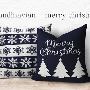 May include: Two square throw pillows. One pillow is white with dark blue horizontal stripes featuring snowflake patterns. The other pillow is dark blue with white text reading Merry Christmas above three white stylized Christmas tree silhouettes.