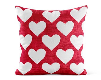 May include: Red throw pillow with a white heart pattern.