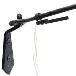 May include: A black metal curtain rod bracket with a decorative design. The bracket has a curved arm, a threaded rod, and a small rectangular piece. Two screws secure the bracket to a surface. A white string hangs from the bracket.