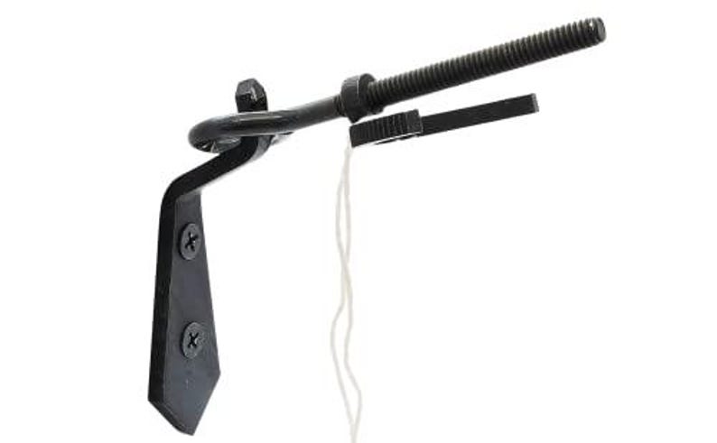 May include: A black metal curtain rod bracket with a decorative design. The bracket has a curved arm, a threaded rod, and a small rectangular piece. Two screws secure the bracket to a surface. A white string hangs from the bracket.