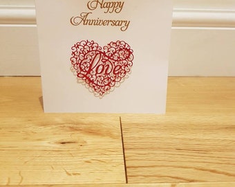 Intricate "love" design anniversary card