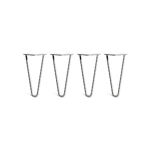 May include: Set of four silver metal hairpin table legs. Each leg is shaped like a V and has a flat top plate.