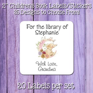 May include: A white square label with a pink and gold crescent moon with a small elephant sitting on it. The label says "For the library of Stephanie" and "With Love, Grandma". There are 20 labels per set.