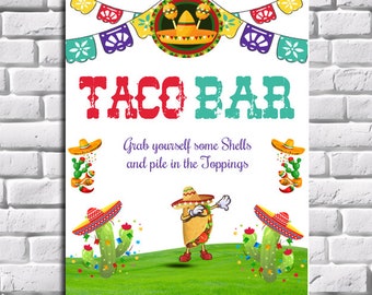 May include: A colorful "TACO BAR" sign with festive decorations. The sign features a cartoon taco character, cacti, and the text "Grab yourself some Shells and pile in the Toppings."