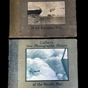 May include: Two vintage books titled "Collier's Photographic History" are displayed. The top book is "of the European War" and the bottom book is "of the World's War." Each book features a black and white photograph on the cover.