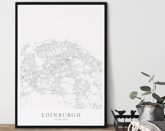 May include: Black and white line art print of a map of Edinburgh, Scotland. The print is framed in a black frame and is hanging on a white wall.