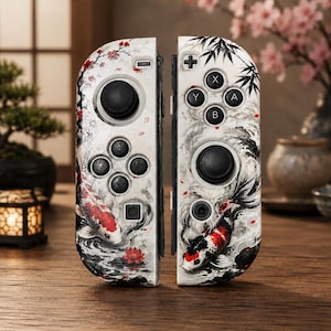 May include: A pair of game controllers featuring a white base with a detailed graphic print of red and black koi fish, flowing water, cherry blossoms, and bamboo stalks. The controllers include black joysticks, directional buttons, and action buttons.