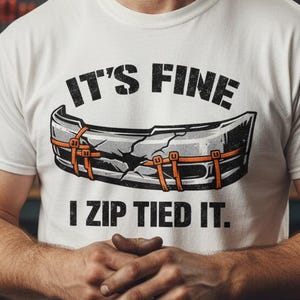 May include: A white ceramic mug with a black handle and the text "But First, Coffee" in a bold, black font. The mug is set against a blurred background, suggesting a cozy setting.