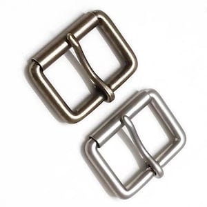 May include: Two metal belt buckles, one antique brass and one silver, both with a square shape and a single prong.