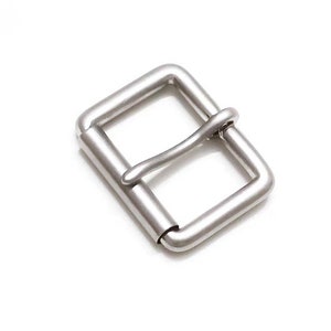 May include: A silver metal buckle for a belt or strap.