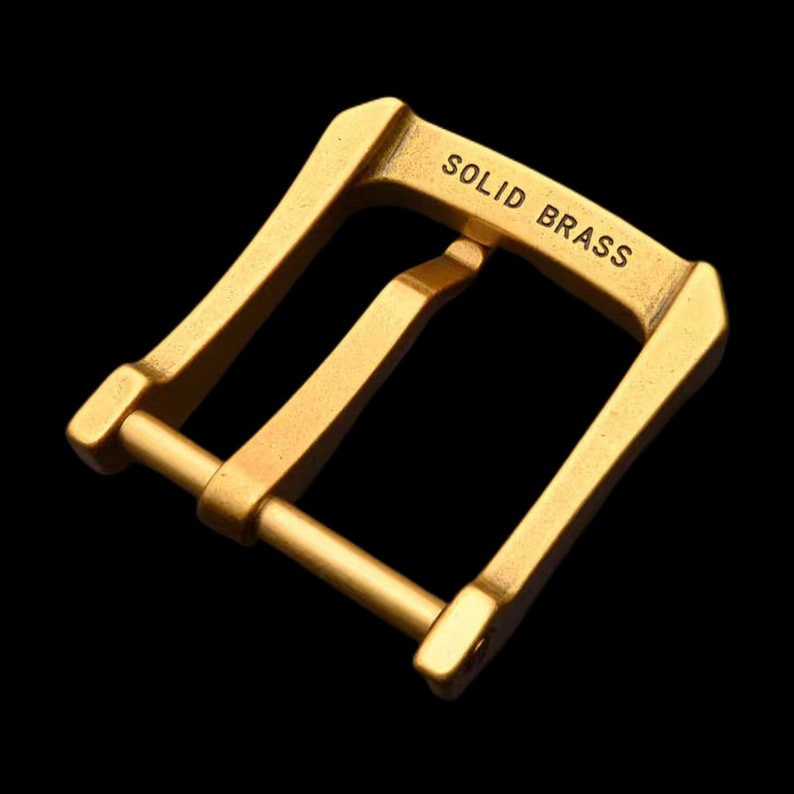 May include: A gold-toned metal buckle with the words "SOLID BRASS" engraved on the top.
