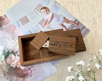 May include: A wooden box with a sliding lid, containing a USB drive with the text "ashley olivia photography" engraved on it. The box is sitting on a table with a white background.
