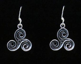 May include: A pair of silver earrings with a Celtic knot design. The earrings are in the shape of a triple spiral, also known as a triskelion.