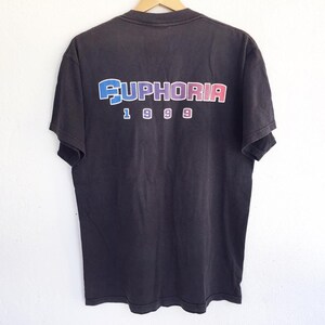 May include: Black t-shirt with a rainbow colored "EUPHORIA 1999" graphic on the back.