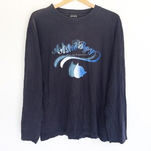 May include: A black long-sleeve shirt with a blue and white graphic print of Astro Boy and the text "Astro Boy &copy;Tezuka Productions".