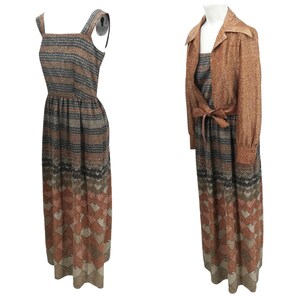 May include: A long brown and black patterned dress with a matching brown jacket. The dress has a sleeveless design and a fitted bodice. The jacket has a collar and long sleeves.