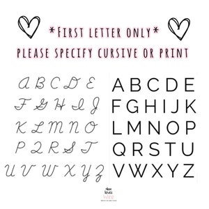 May include: A white background displays the alphabet in both cursive and print styles. The text reads "*FIRST LETTER ONLY* PLEASE SPECIFY CURSIVE OR PRINT". Two black heart doodles are at the top. The bottom right corner has the text "dina loves wire".