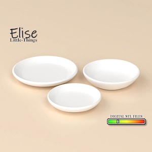May include: Three white ceramic dishes of varying sizes. The dishes are arranged in a row from largest to smallest. The dishes are on a light brown surface. DIGITAL STL FILES