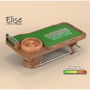 May include: A miniature wooden roulette table with a green felt playing surface and a spinning wheel. The table has a brown wooden base and a metal bar for support. The table is labeled "Elise Little-Things" and "3D Printing Digital STL Files".