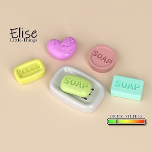 May include: An assortment of colorful soaps in various shapes, including a heart, a circle, and rectangular bars. One bar rests in a white soap dish. The word "SOAP" is imprinted on several bars. The image also includes the text "Elise Little-Things" and "DIGITAL STL FILES".