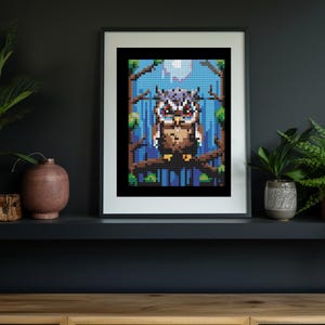 May include: A framed pixel art print of an owl perched on a branch in a forest setting. The owl has brown and gray feathers and yellow eyes. The background is a blue and green gradient with a white moon.