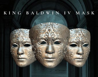 May include: Three gold masquerade masks with intricate floral designs. The masks have eye holes and a small opening for the mouth. The masks are arranged in a row, with the middle mask slightly forward.