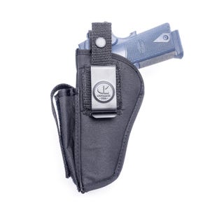 May include: A black nylon holster featuring a metal belt clip with the embossed logo CK OUTBAGS USA. The holster includes a vertical strap with a snap button closure to secure a blue-toned firearm partially inserted into the top opening.