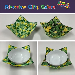 May include: Two fabric bowl cozies, one with a lemon print and one with a black and white bird print. Both cozies are folded and displayed on a white surface.