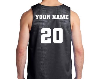 May include: Black basketball jersey with white mesh and white lettering. The jersey has "YOUR NAME" and the number "20" on the back.