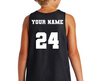 May include: Black basketball jersey with white mesh fabric. The back of the jersey has "YOUR NAME" and the number "24" printed in white.