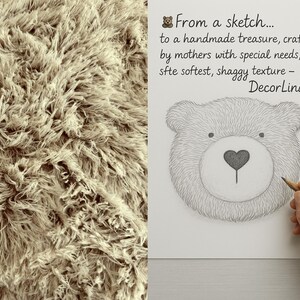 The image is a collage of two separate images. On the left, there is a close-up of a fuzzy, textured surface, possibly a carpet or a blanket. On the right, there is a hand holding a pencil, drawing a sketch of a bear's face. The text accompanying the image reads, "From a sketch... to a handmade treasure, crafted by mothers with special needs, using site softest, shaggy texture - Decorina".