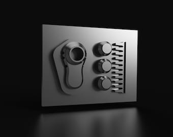 Może przedstawiać: Srebrny metalowy panel z wypukłym wzorem stopy i trzech okrągłych gałek. Panel ma fakturowaną powierzchnię i lekko zaokrąglony brzeg.