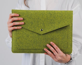 May include: A lime green felt laptop sleeve with a rectangular shape and a triangular envelope-style flap. The sleeve features a single silver-toned metal snap button closure centered on the flap, providing a secure way to hold a laptop or documents.