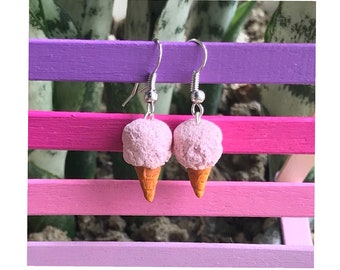 May include: A pair of pink and orange ice cream cone earrings. The earrings are made of polymer clay and have silver hooks.