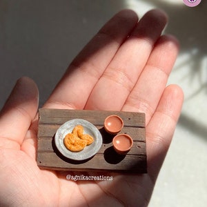 Miniature Prajapati (butterfly shaped) Biscuits with Bharer Cha (tea served in earthen pots)