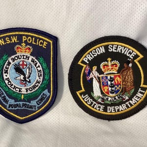 Nya Zeelands polis och fängelsetjänstens tygmärken - par