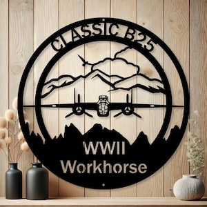 May include: Black metal sign with a silhouette of a B-25 bomber plane flying over mountains. The sign reads "Classic B-25 WWII Workhorse".